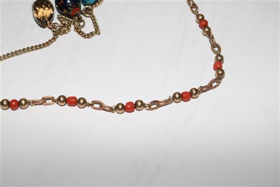 A 9ct gold necklace hung with four egg shaped charms and a 9ct gold and coral bead necklace.